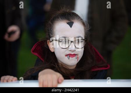 Ascot, Berkshire, UK. 30th October, 2021. Young racegoers have their faces painted and dress up for Halloween. It was a busy day at Ascot Racecourse today for the first of the jumps season. Families also enjoyed the funfair and Halloween activities for the children. Credit: Maureen McLean/Alamy Stock Photo