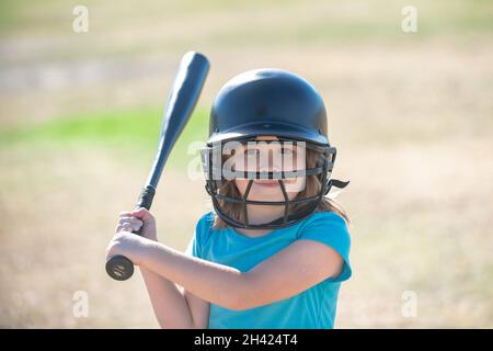 Little child baseball player focused ready to bat. Kid holding a baseball bat. Stock Photo