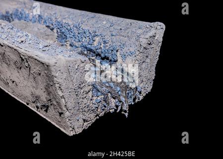 Residues of frozen metal after smelting and casting. Hardened steel metallurgy and industry. Stock Photo