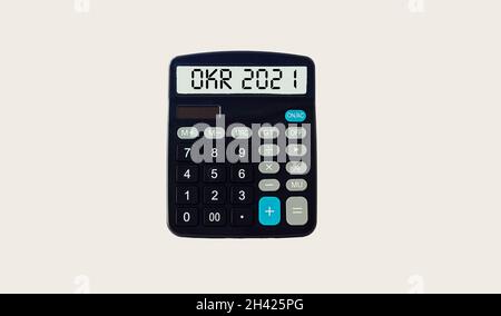 OKR Goals and Key Results 2021 - word on calculator display and light background. Business and finance concept Stock Photo