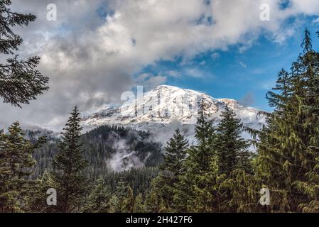 The Mt Rainier hiding behind clouds, seen from the Nisqually river, USA Stock Photo