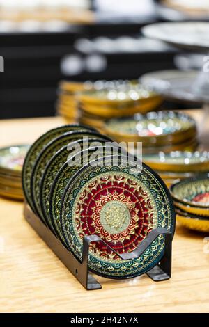 Selective focus of Decorative painted plates on stand with kitchenware. Hand drawn pattern in turkish style. Islam, Arabic and Indian. background for Stock Photo