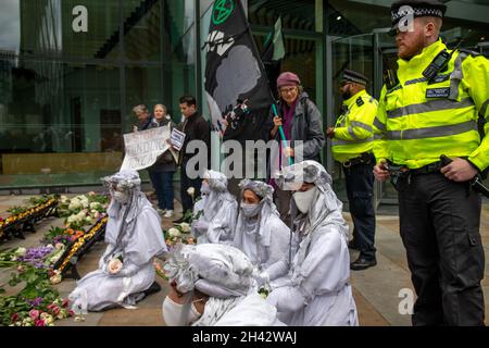 London, England, UK 29 October 2021 XR Greenwich and Stop Silvertown Tunnel Coalition join with other groups from around the world for the Defund Climate Chaos day, gathering at Macquarie Capital to demand they stop profitting from climate chaos. Rebels dressed as banshees join the group, wailing as they mourn for the destruction of the planet Stock Photo