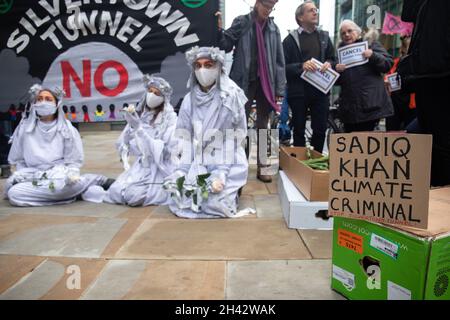 London, England, UK 29 October 2021 XR Greenwich and Stop Silvertown Tunnel Coalition join with other groups from around the world for the Defund Climate Chaos day, gathering at Macquarie Capital to demand they stop profitting from climate chaos. Rebels dressed as banshees join the group, wailing as they mourn for the destruction of the planet Stock Photo