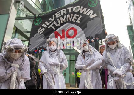 London, England, UK 29 October 2021 XR Greenwich and Stop Silvertown Tunnel Coalition join with other groups from around the world for the Defund Climate Chaos day, gathering at Macquarie Capital to demand they stop profitting from climate chaos. Rebels dressed as banshees join the group, wailing as they mourn for the destruction of the planet Stock Photo