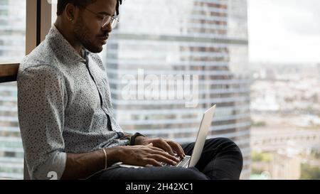 Happy creative african hipster man working on computer. Stock Photo