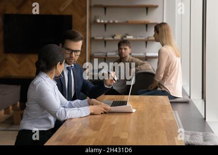Concentrated mixed race colleagues working on computer. Stock Photo