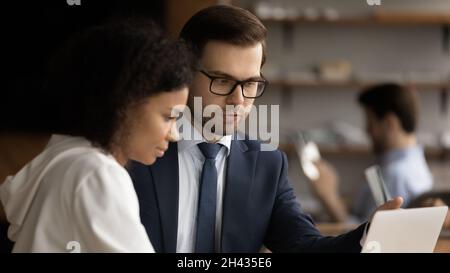 Focused diverse employees working on computer in office. Stock Photo