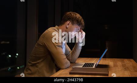 Anxious stressed young businessman working on computer. Stock Photo