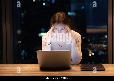 Stressed nervous young businesswoman stuck with difficult task. Stock Photo