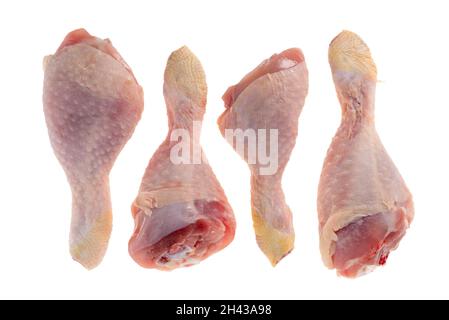 Four raw chicken legs on isolated white ground in top view Stock Photo