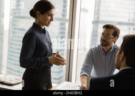 Happy female leader holding negotiations meeting in office. Stock Photo