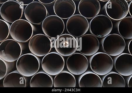 Labuan Bajo, Indonesia - Aug 25, 2019: Texture of dark metal pipes, stacked in the port of Labuan Bajo Stock Photo