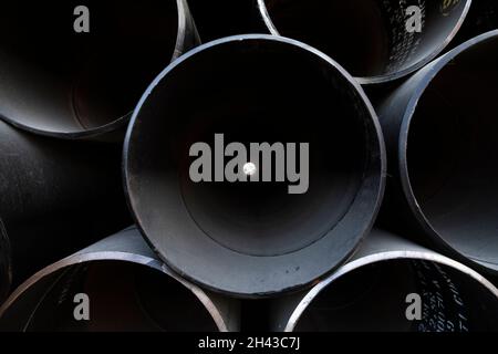 Labuan Bajo, Indonesia - Aug 25, 2019: Texture of dark metal pipes, stacked in the port of Labuan Bajo Stock Photo