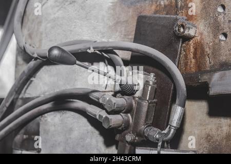 System of connection of hoses and tubes with handle of the old machine of the equipment in the workshop at the industrial plant. Stock Photo