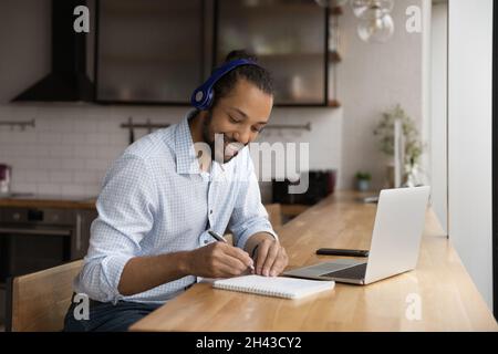 Happy young african american man e-learning at home. Stock Photo
