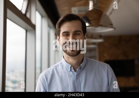 Happy candid young caucasian man looking at camera. Stock Photo