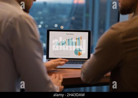 Close up focus on laptop screen with project statistics. Stock Photo