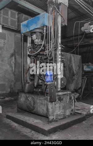 Old equipment or machine with tube and hose system and electric flange motor in the workshop of an industrial plant. Stock Photo