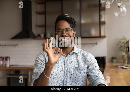 Happy young african ethnicity man showing okey gesture. Stock Photo