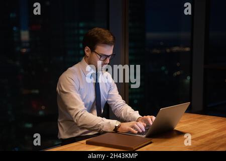 Focused serious young businessman working on computer. Stock Photo