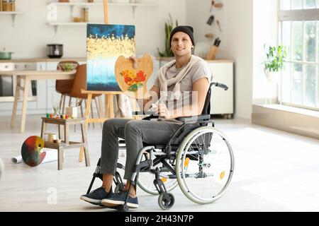 Young handicapped artist painting in workshop Stock Photo