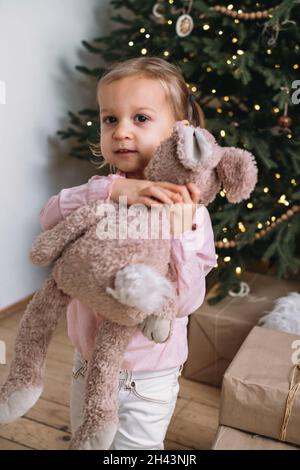 happy merry child in bunny ears and with Easter colored eggs Stock ...