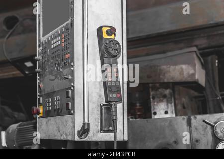 Large old shield with buttons and panel control panel lifting mechanism crane in the workshop of the industrial plant. Stock Photo
