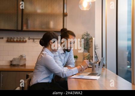 Concentrated mixed race employees working on computer. Stock Photo