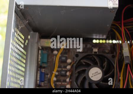 An old family computer filled with spider webs, dust and viruses. Maintenance is a key to keep computers healthy and working. Stock Photo