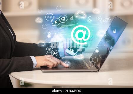 Hands working on laptop with digital icons concept Stock Photo