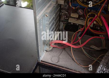 An old family computer filled with spider webs, dust and viruses. Maintenance is a key to keep computers healthy and working. Stock Photo