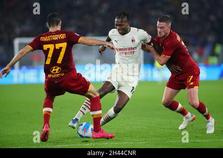 Rafael Leao of Milan (C) vies for the ball with Henrikh Mkhitaryan (L) and Jordan Veretout (R) of Roma during the Italian championship Serie A football match between AS Roma and AC Milan on October 31, 2021 at Stadio Olimpico in Rome, Italy - Photo Federico Proietti / DPPI Stock Photo