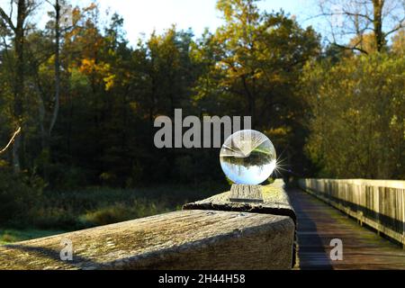 scenic view of the wooden railing through a crystal ball Stock Photo