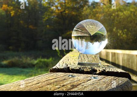 scenic view of the wooden railing through a crystal ball Stock Photo
