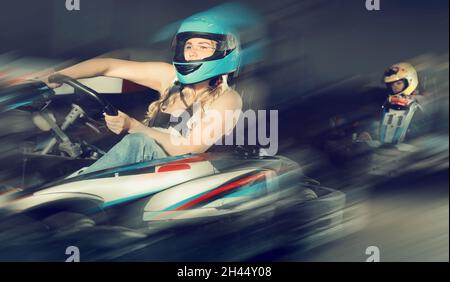 woman driving racing car at kart circuit Stock Photo