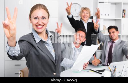 Businesswoman and team delighted with achievements Stock Photo