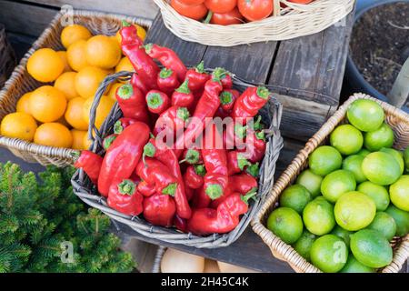 three baskets of fresh red pepper , limes and oranges  in celebration Harvest time in London Greenwich England UK Stock Photo