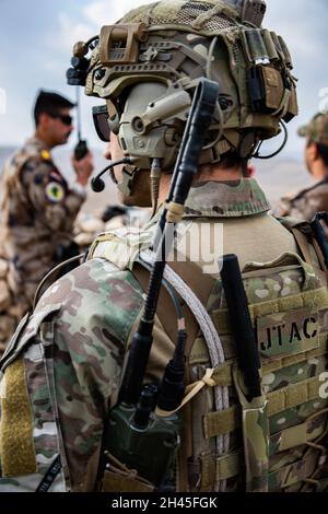 An Iraqi Terminal Attack Controller (ITAC) identifies a target during ...