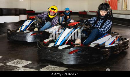 People driving go-kart cars Stock Photo