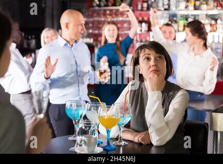 Sad woman at office party Stock Photo