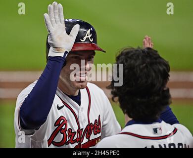 The Braves' Dansby Swanson high fives teammates prior to a game against the  Arizona Diamondbacks on Monday, Aug…