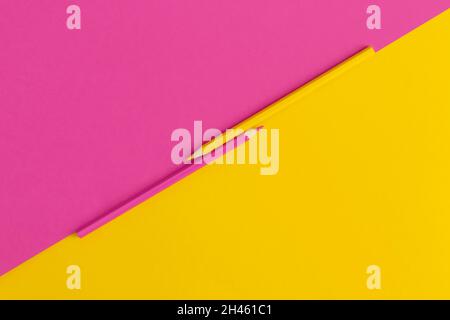 Colored pencils on yellow, pink background. Top view with copy space. Flat lay. Back to school concept. Stock Photo