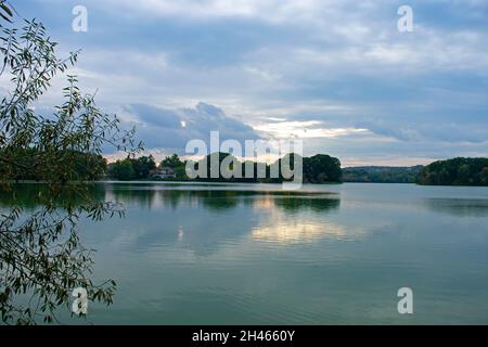 Clouds and trees reflecting on the still waters of Spy Pond, in Arlington, Massachusetts, on a cloudy autumn day -02 Stock Photo