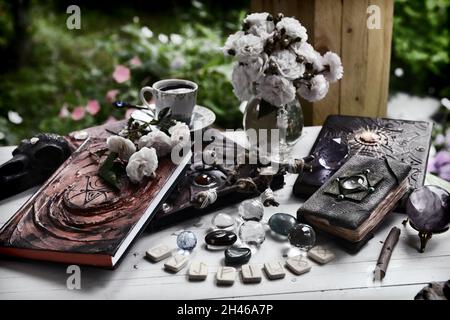 Old book of spells with runes, pentagram and candles on witch ritual ...