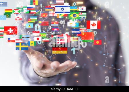 Person presenting the virtual projection of international country flags with binary codes Stock Photo