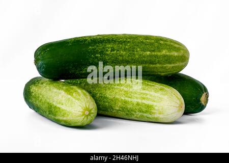 Four cucumbers for greens, in a stack composition, isolated on a white background, copy space Stock Photo