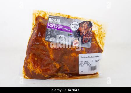 Johannesburg, South Africa - Woolworths Food moroccan styled pork rib eye steaks isolated on a clear background Stock Photo