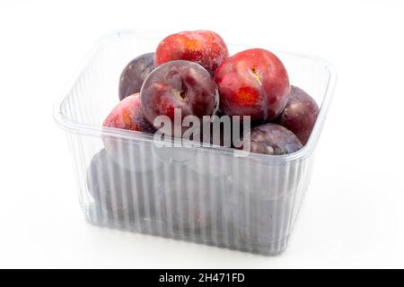 Packed black plum on a white background. Combined with a mature black plum shade. close up Stock Photo