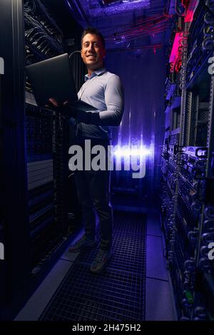 System administrator smiling at camera during server testing Stock Photo